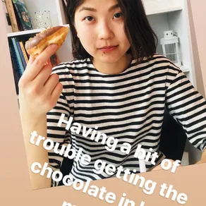 Having a bit of trouble getting the chocolate in her mouth